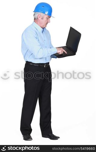 Senior architect typing on laptop