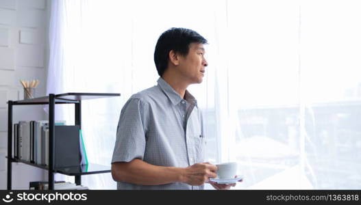 Senior Asian man drinking coffee on relaxing time