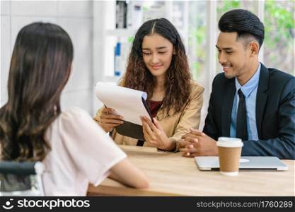 Senior Asian Manager explaining or answering about job description and benefits to Young Asian woman graduate with positive motion in meeting room,Business Hiring new member concept