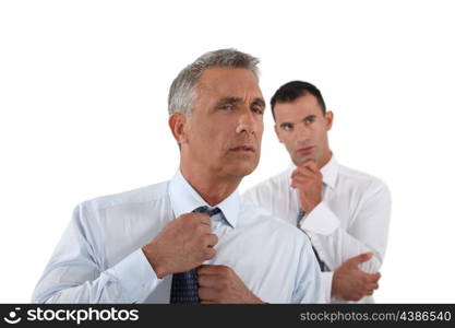 Senior businessman adjusting tie