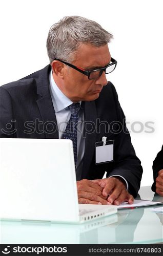 Senior businessman attentively listening to colleague