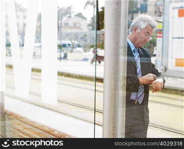 Senior businessman checking watch