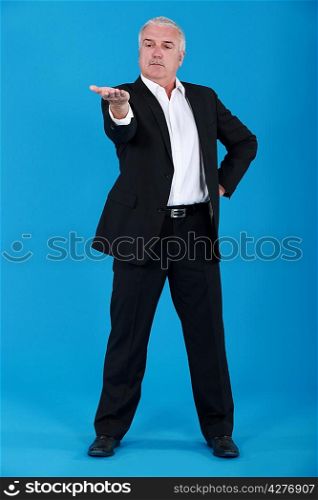 Senior businessman gesturing with his hand