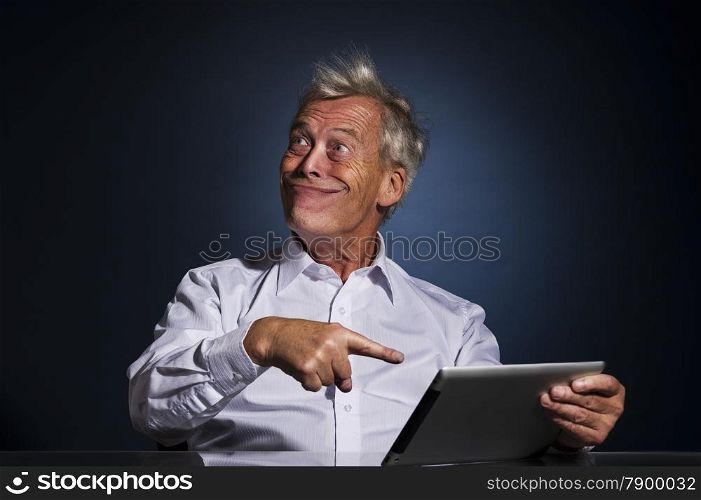 Senior businessman grinning with a look of fatuous self-satisfaction and pointing to his tablet computer with his finger as though indicating a great personal achievement, comic studio portrait
