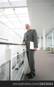 Senior businessman posing in the corridor