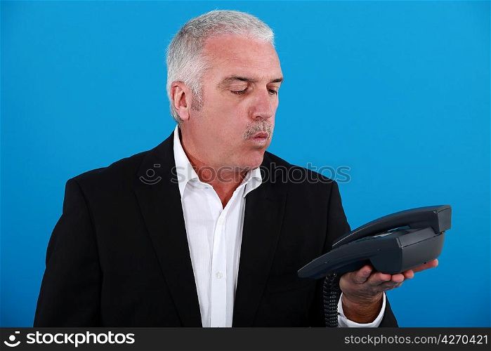 Senior businessman waiting for the phone to ring