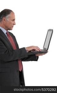 Senior businessman with a laptop