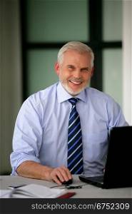 Senior businessman with a laptop