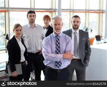 senior businessman with his team at office. business people group