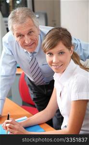 Senior businessman with young woman in the office