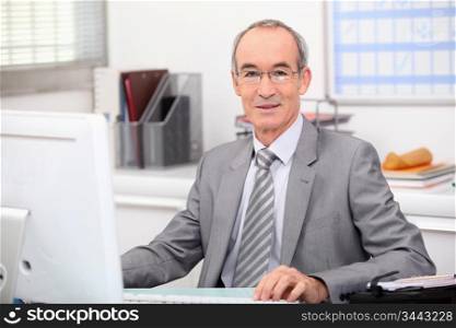 Senior businessman working at a computer