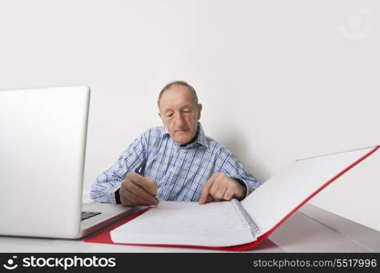Senior businessman working at office desk
