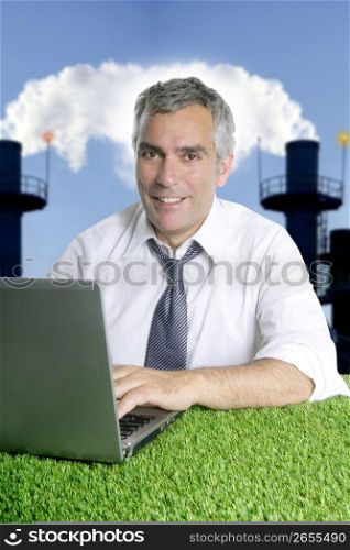 senior businessman working green grass desk computer smog indutrial smoke pollution