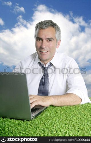 senior businessman working green grass desk outdoor blue sky