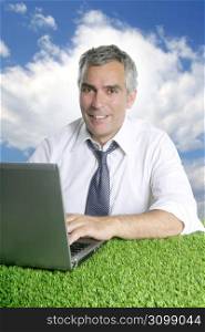 senior businessman working green grass desk outdoor blue sky