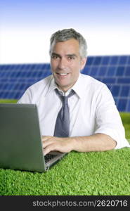 senior businessman working green grass desk solar plates