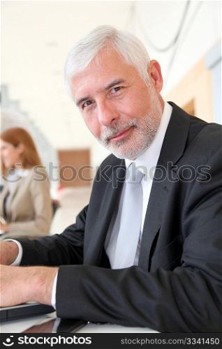 Senior businessman working on laptop computer