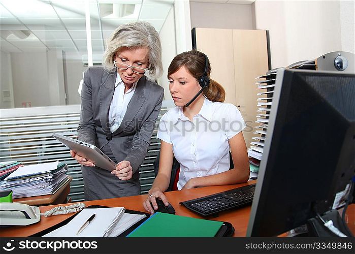 Senior businesswoman in office with young woman