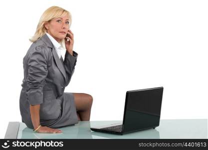 Senior businesswoman sitting on her desk