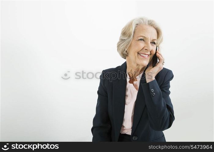 Senior businesswoman using cell phone in office