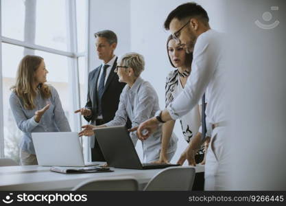 Senior businesswoman working together with young business people in the office