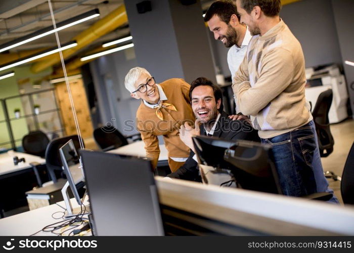 Senior businesswoman working together with young business people in the office