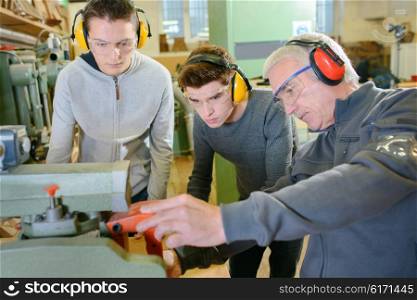 Senior carpenter with two learners