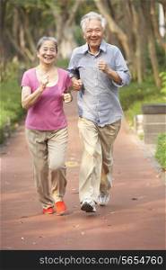 Senior Chinese Couple Jogging In Park
