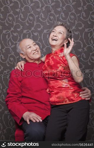 Senior Chinese Couple Laughing in Traditional Clothing