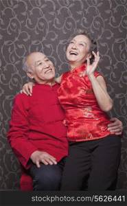 Senior Chinese Couple Laughing in Traditional Clothing