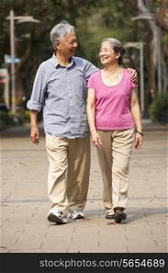 Senior Chinese Couple Walking In Park