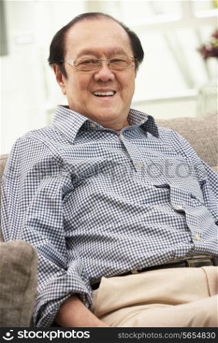 Senior Chinese Man Relaxing On Sofa At Home