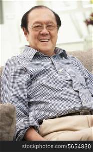 Senior Chinese Man Relaxing On Sofa At Home