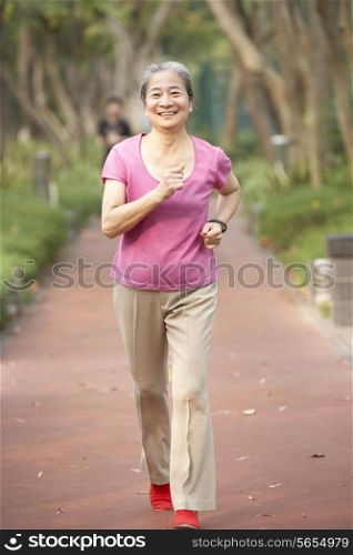 Senior Chinese Woman Jogging In Park