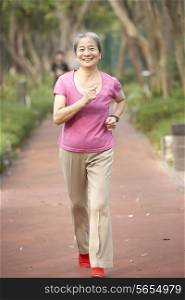 Senior Chinese Woman Jogging In Park