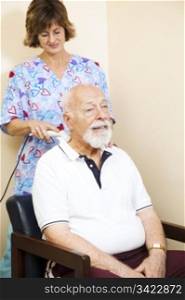 Senior chiropractic patient gets relief from neck pain through ultrasound technology.