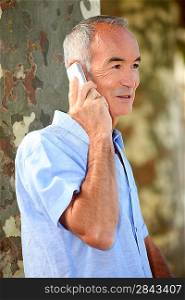 senior citizen making a call outdoors
