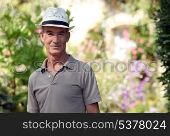 Senior citizen relaxing in his garden