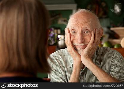 Senior couple at home focusing on man