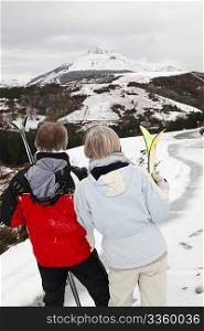 Senior couple at ski resortlooking at the mountain