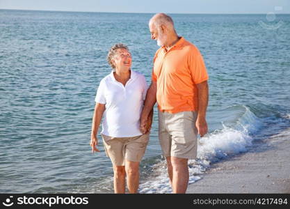 Senior couple at the beach, looking into each others eyes.