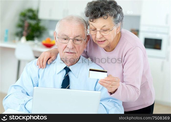 senior couple buying on internet with credit card