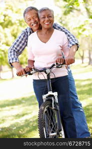 Senior couple cycling in park