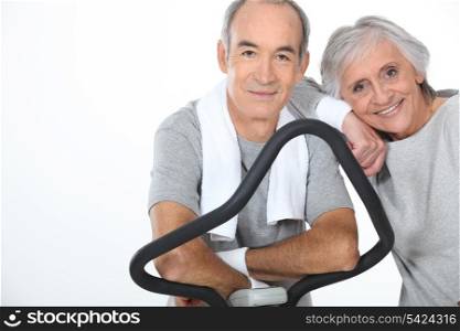 senior couple doing exercises in the gym