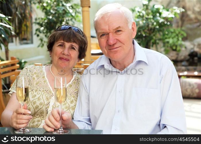 senior couple drinking champagne and celebrating together