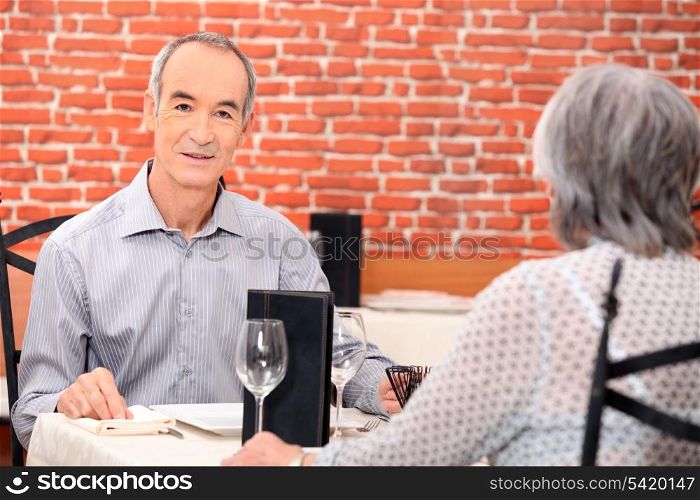 Senior couple eating a meal in a restaurant