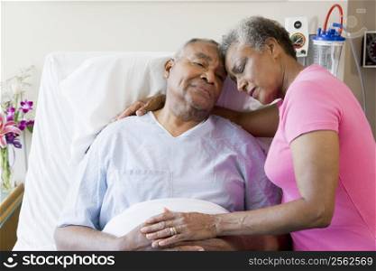Senior Couple Embracing In Hospital