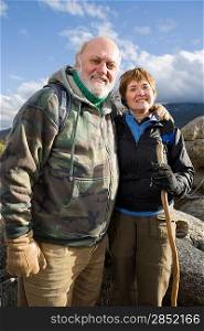 Senior couple embracing in mountains, portrait