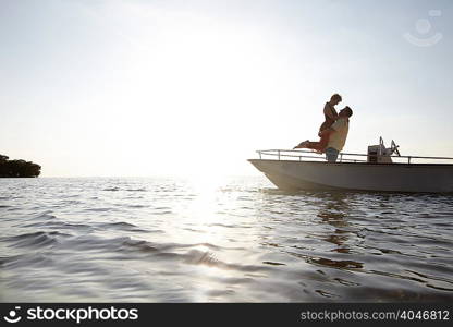 Senior couple embracing on motorboat