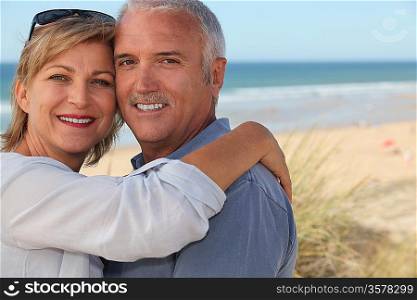 senior couple embracing on the beach